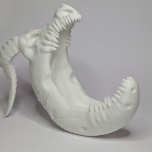 White 3D printed dragon sculpture wrapped around a crescent moon with open jaws and textured scales