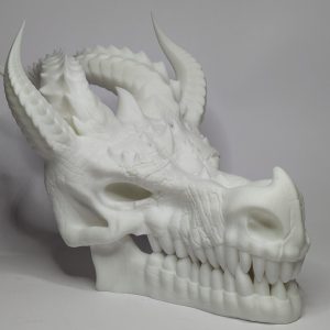 White 3D printed dragon skull sculpture with horns and detailed teeth