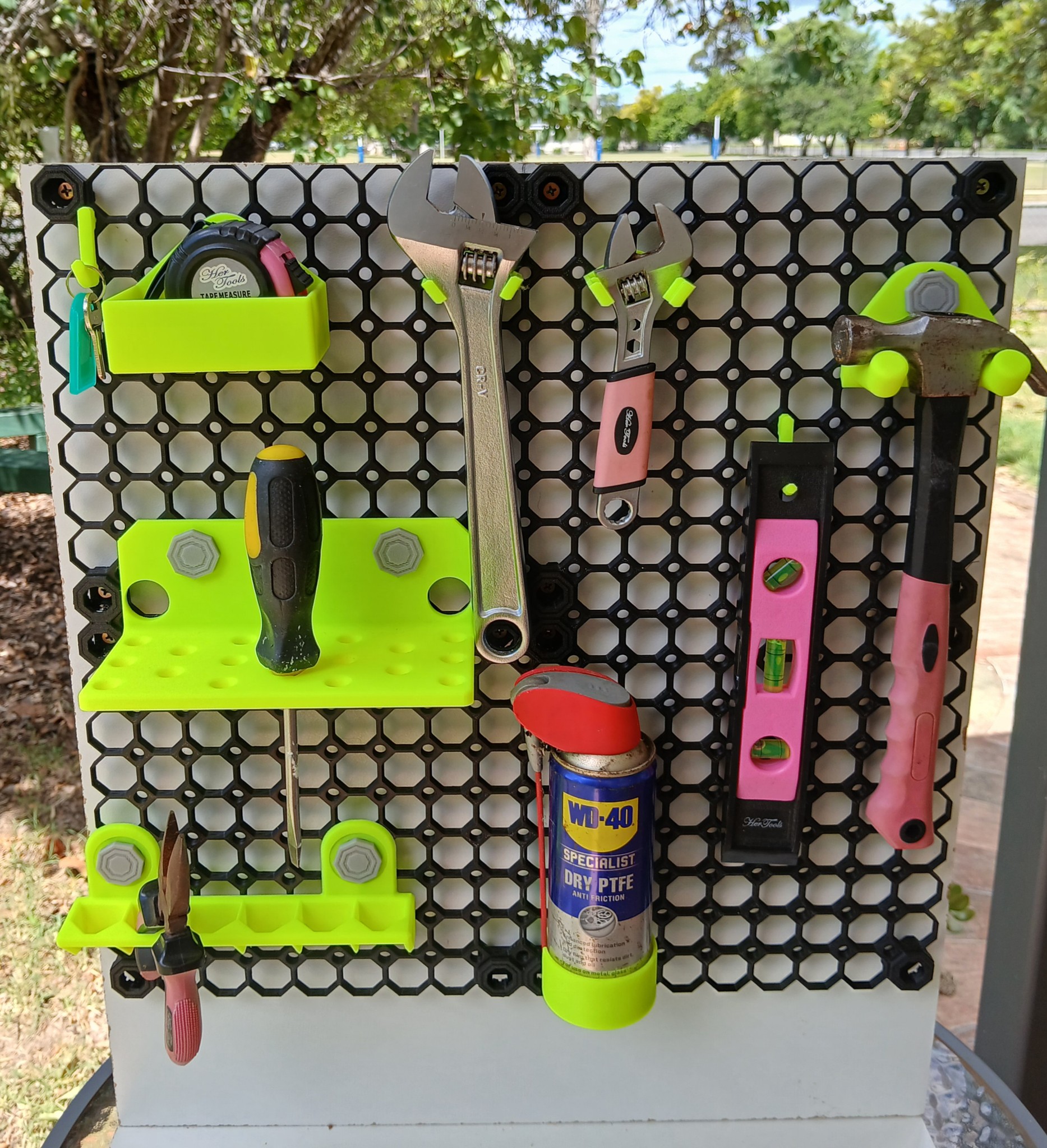 Multiboard wall-mounted tool holders with various hand tools organized and displayed