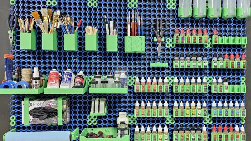 Organized craft room with multiboard wall storage system displaying various supplies and tools