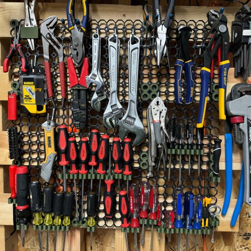 Multiboard garage pegboard with various hooks and storage accessories mounted on wall